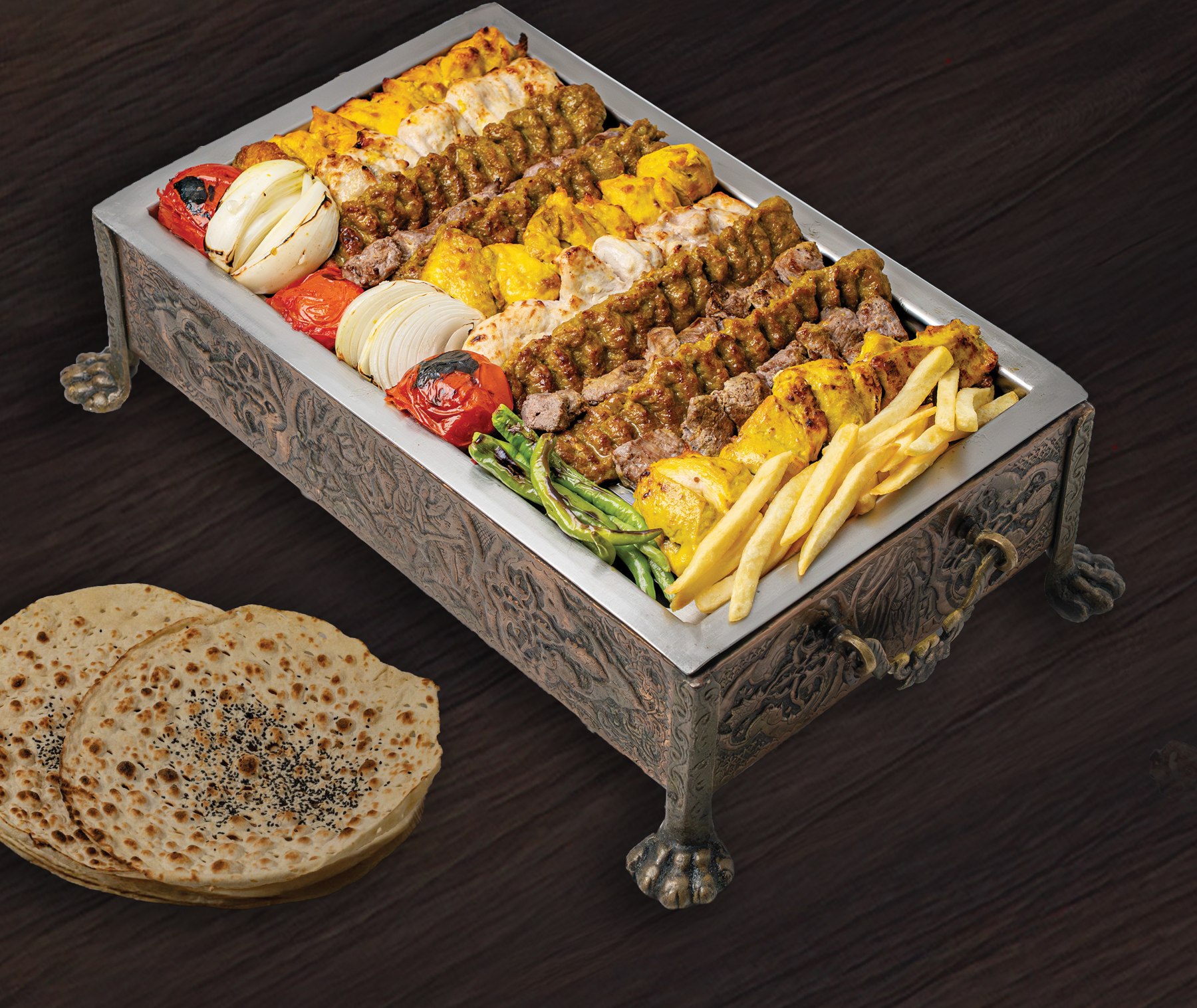 A Kish Persian grill selection presented in an ornate serving tray